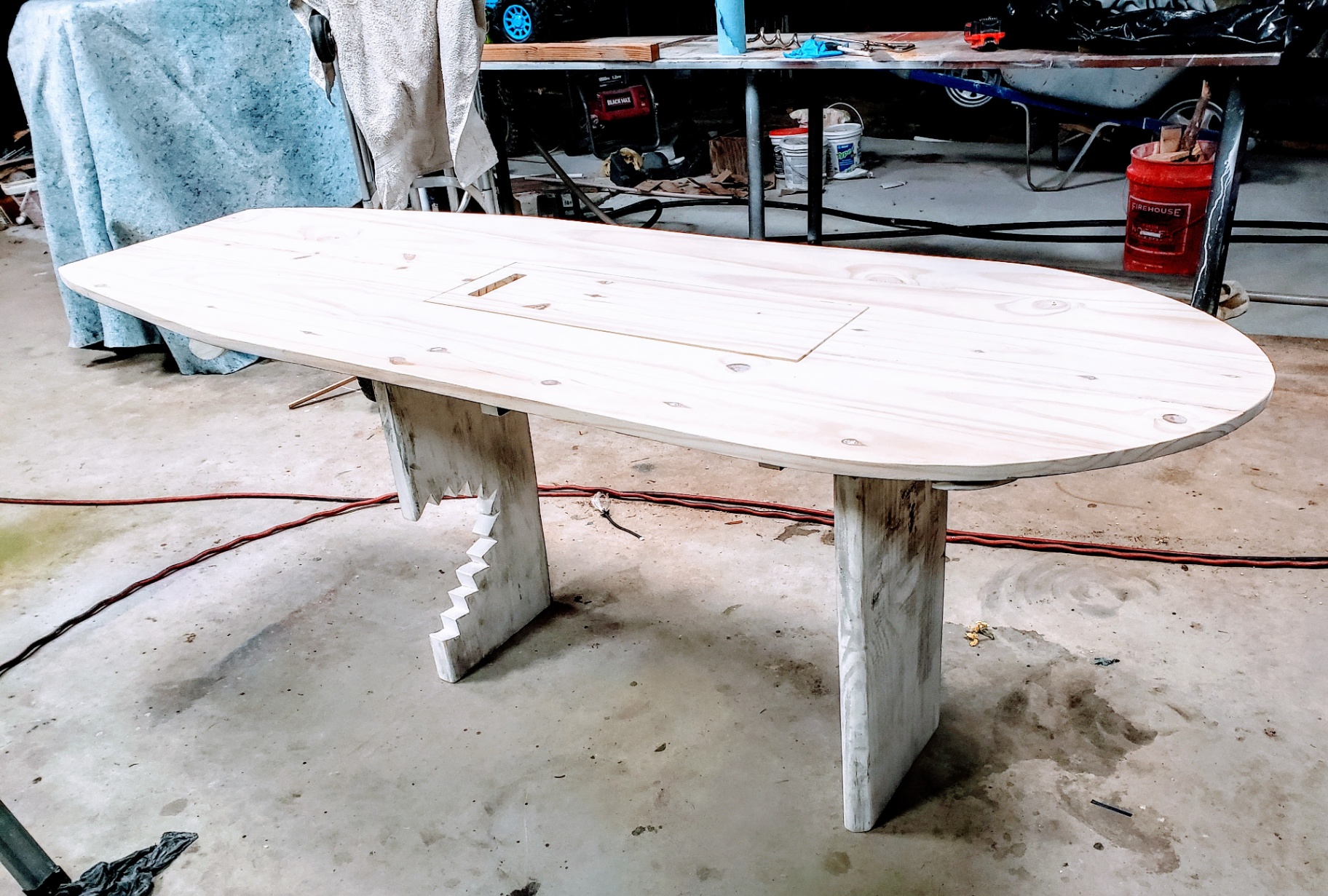 Assembly — raw surfboard top on the shark-bitten base.