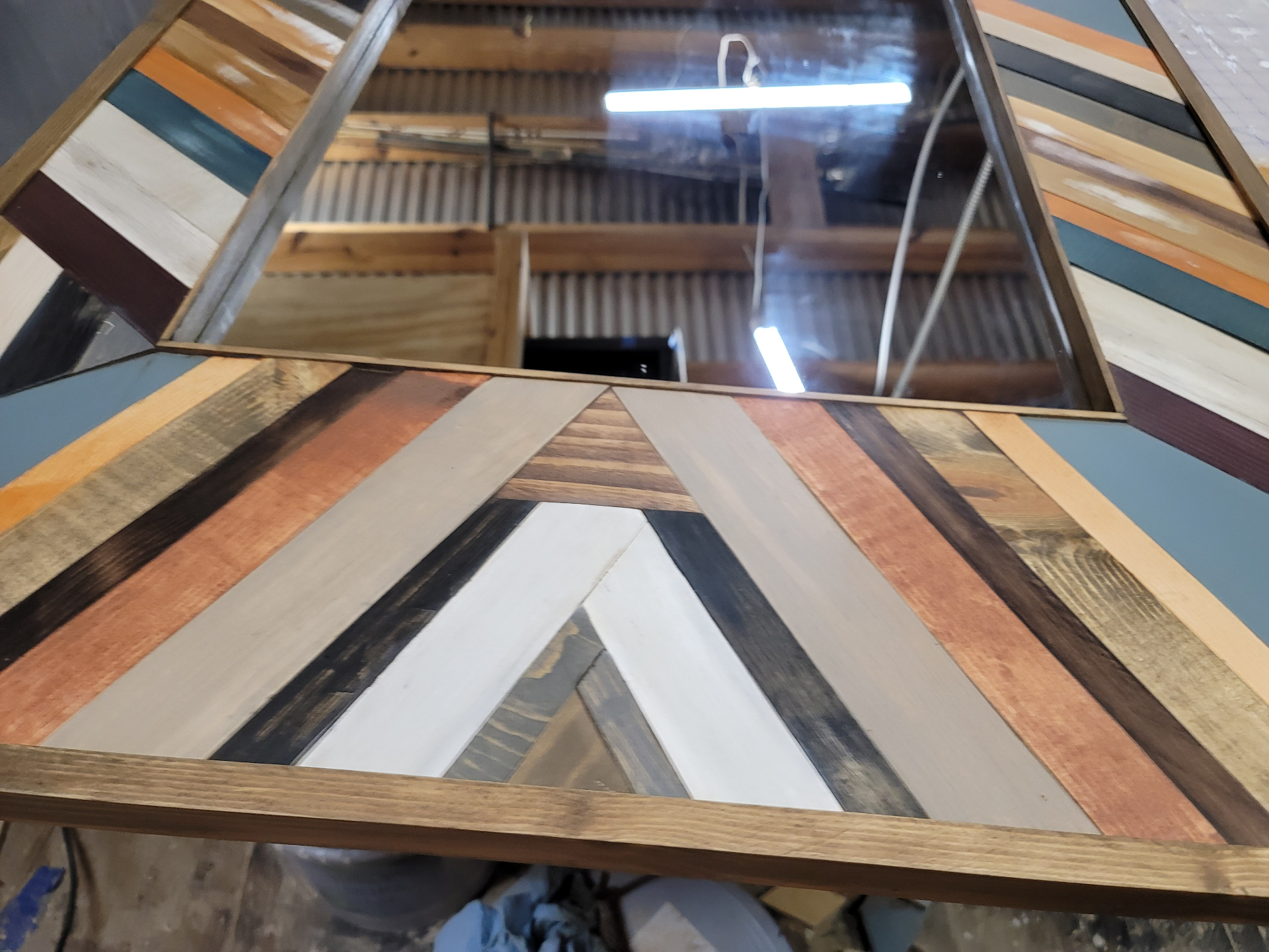 Chevron detail at the top of the mirror frame.