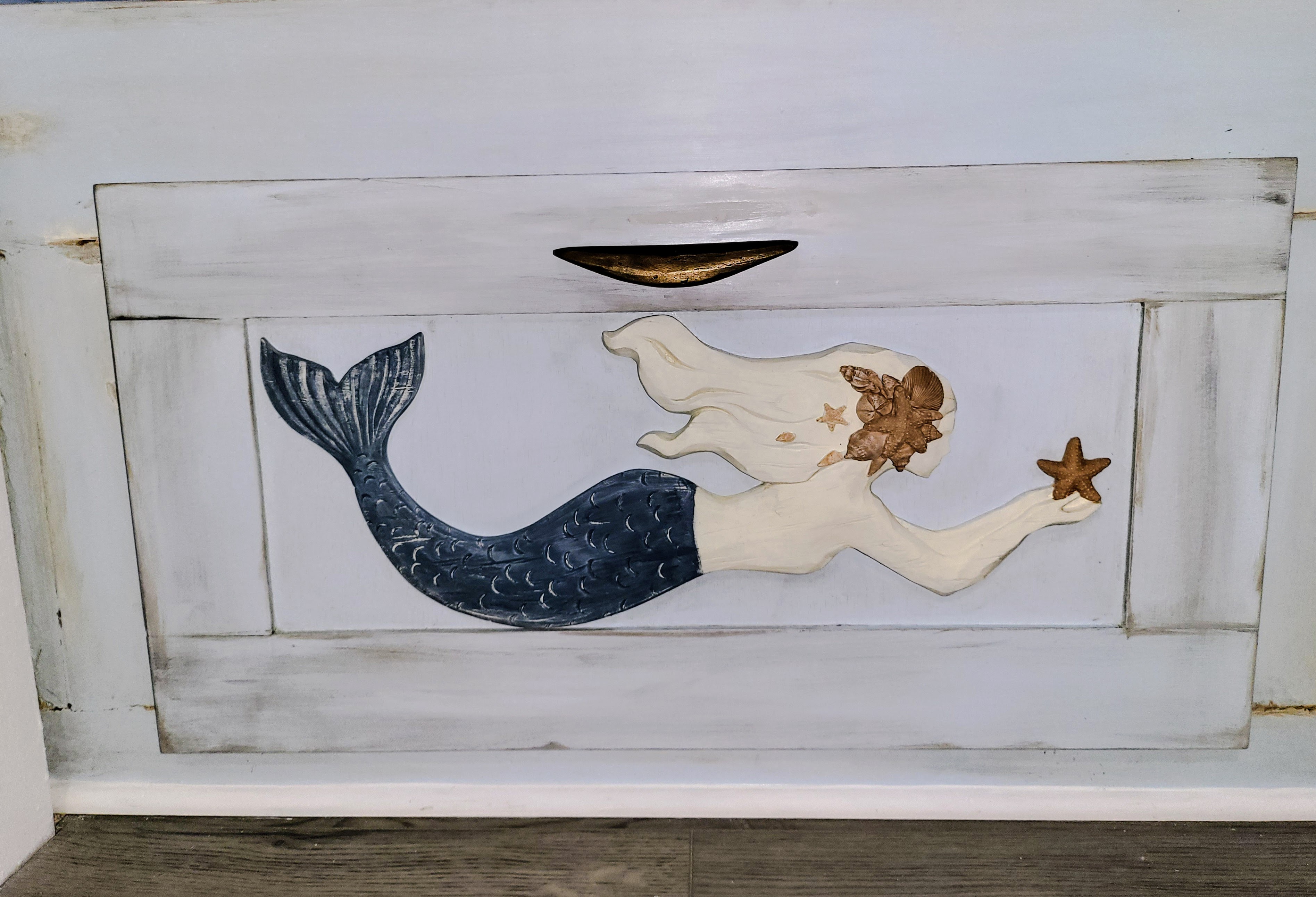 Close-up of the hand-painted mermaid drawer.