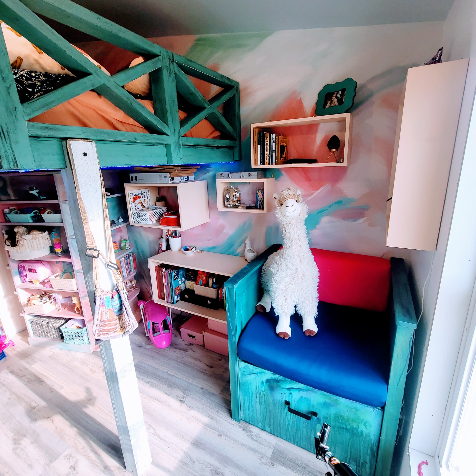 Reading nook, floating shelves and dreamy painted walls beneath the loft.