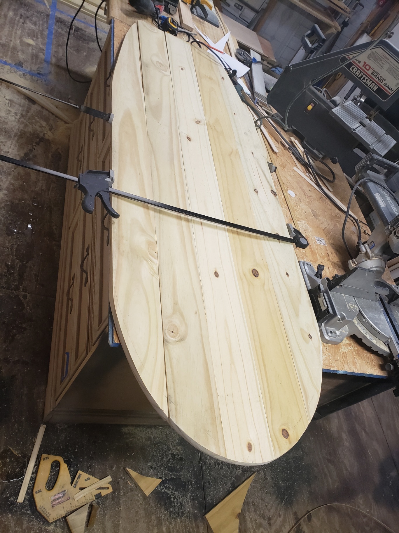 Raw surfboard tabletop being glued up in the workshop.