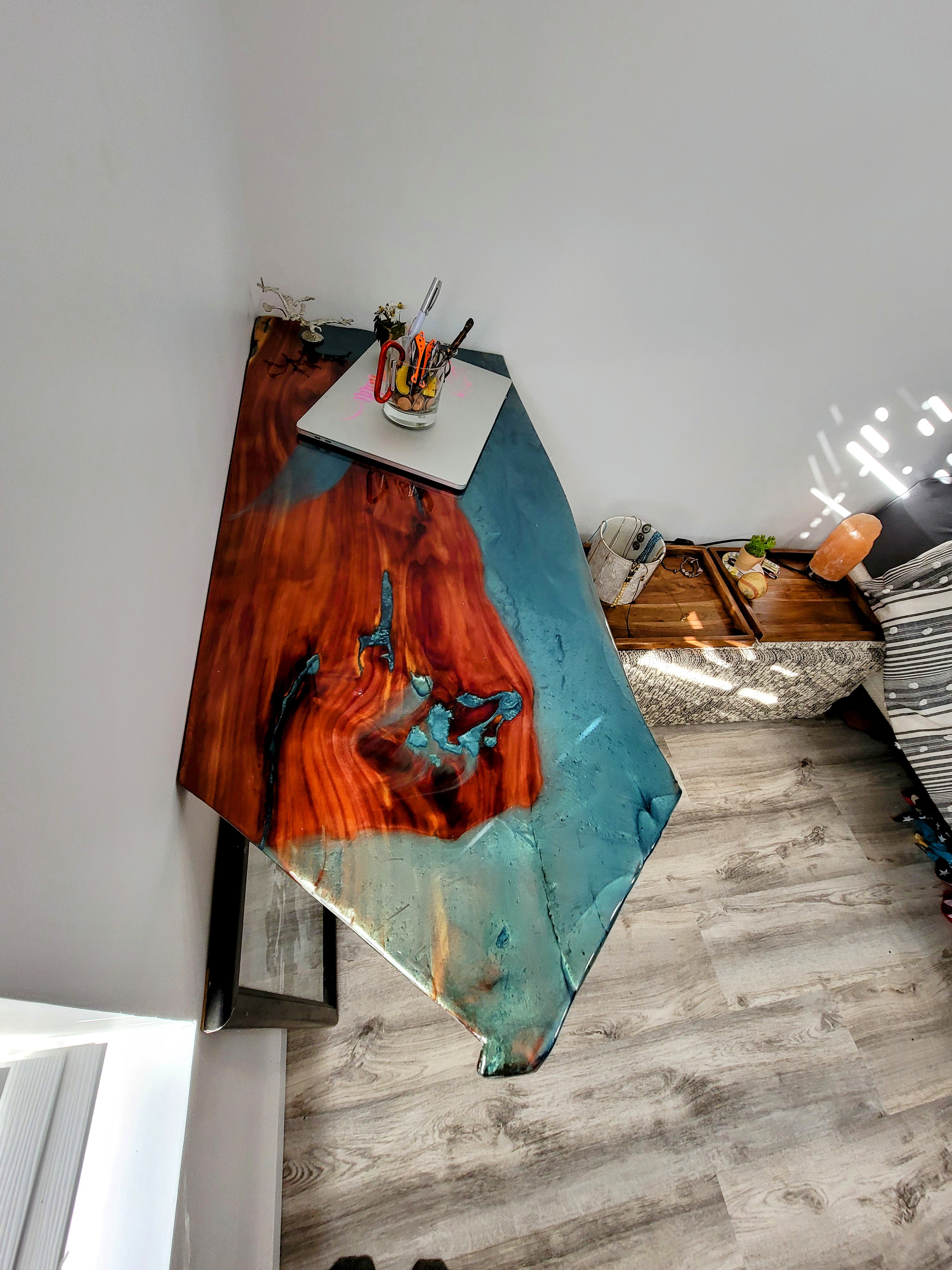 Live-edge cedar floating desk finished in epoxy for work and creativity.