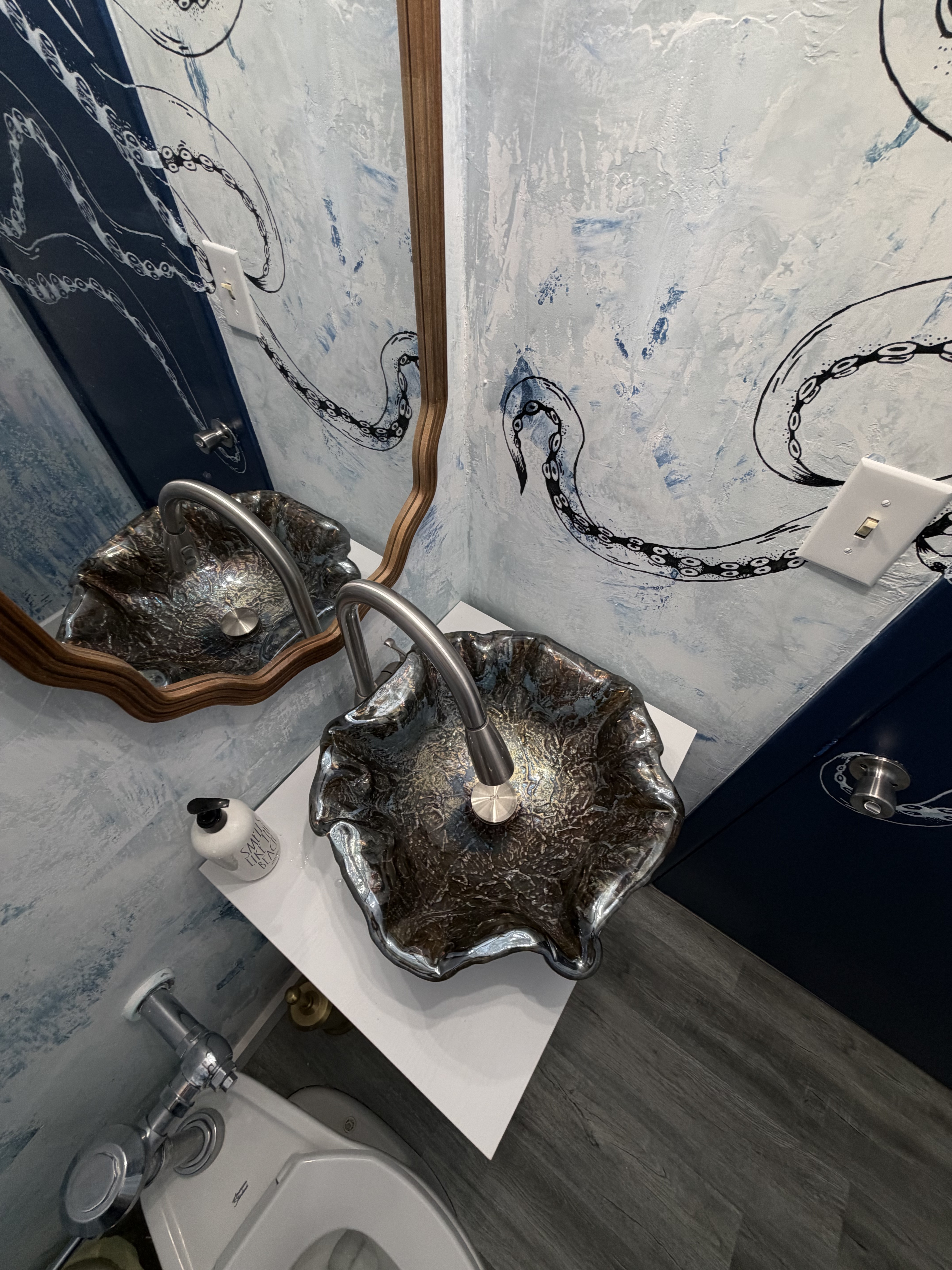 One of the favorite details — the octopus mural winding across the textured walls.