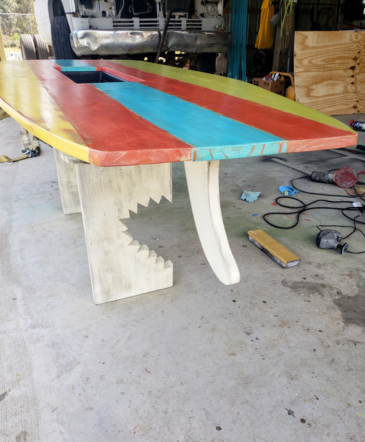 Sun-faded coral, turquoise and citrus yellow surfboard top.