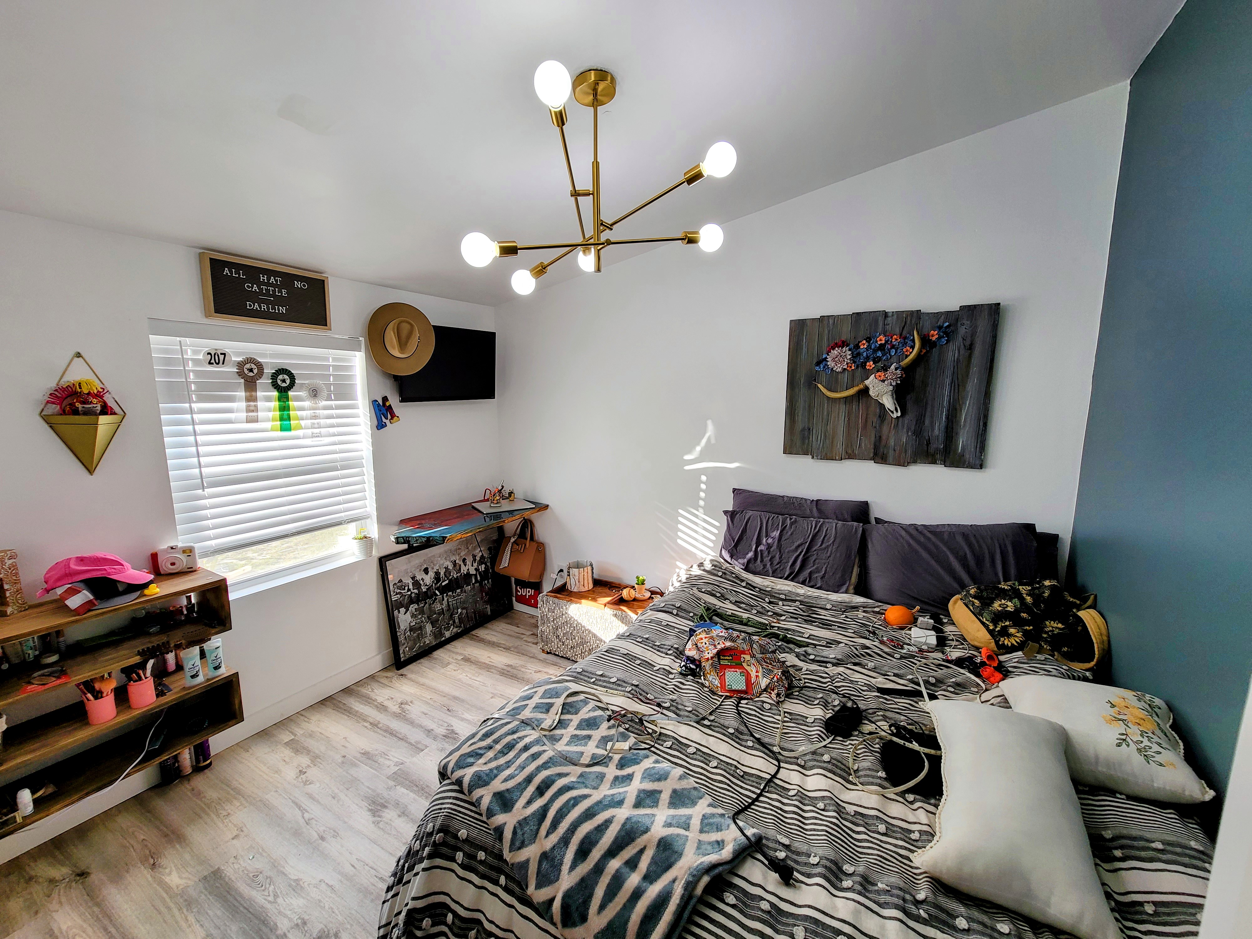 The finished bedroom balancing soft boho details with Wild West character.