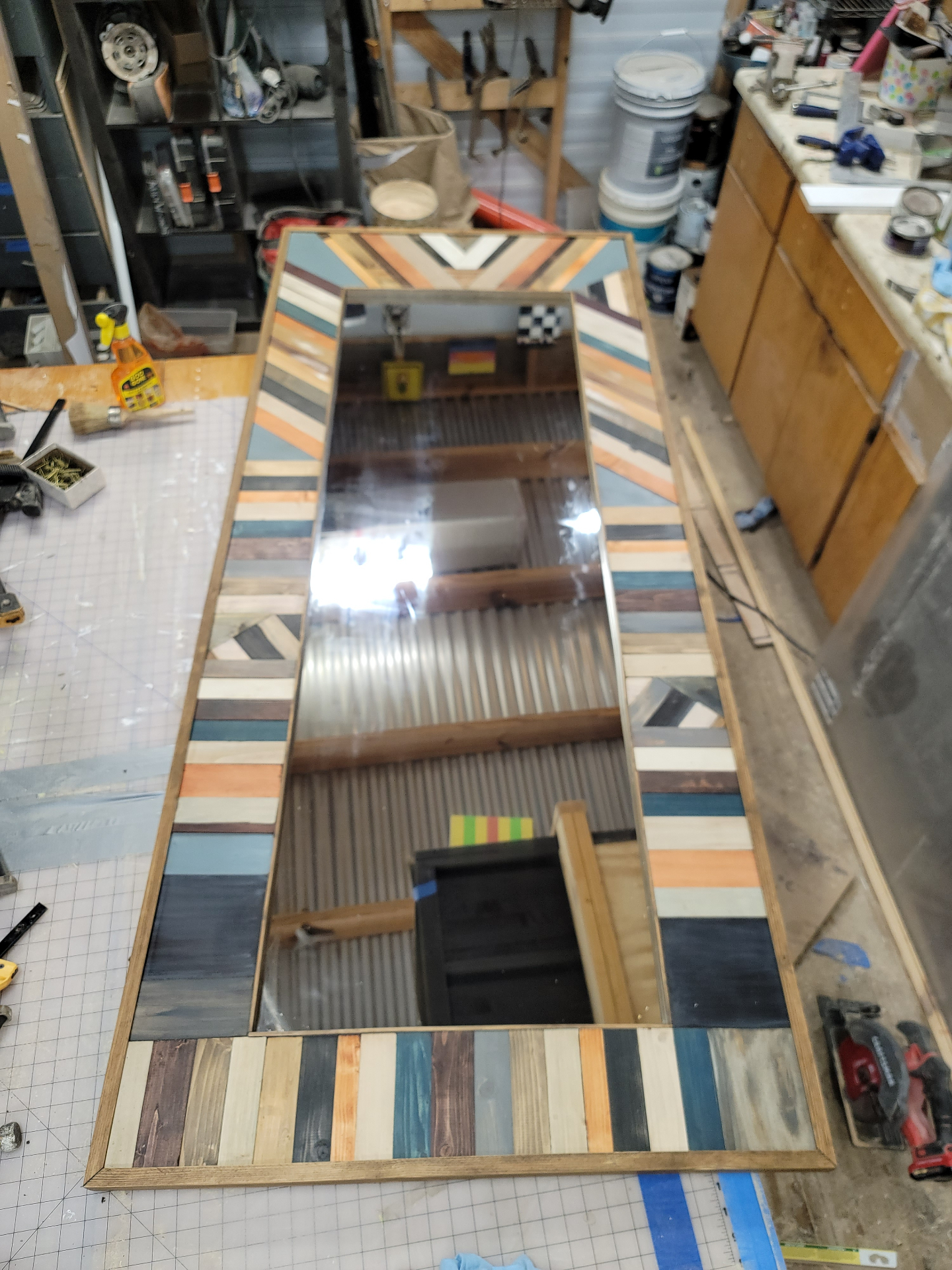 Top view of the painted and stained wood mosaic surrounding the mirror.