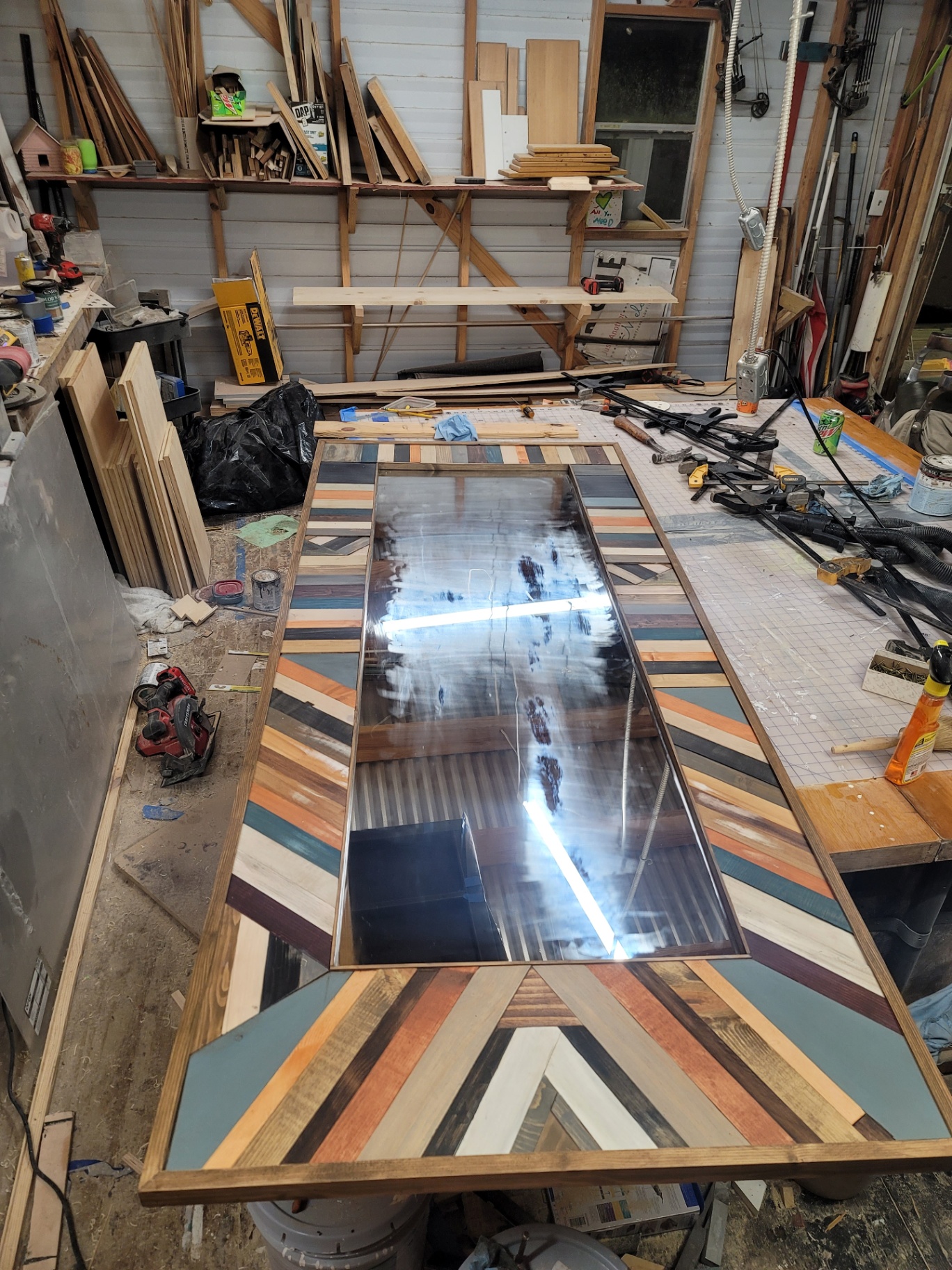 Oversized mosaic mirror laid out in the workshop during the build.