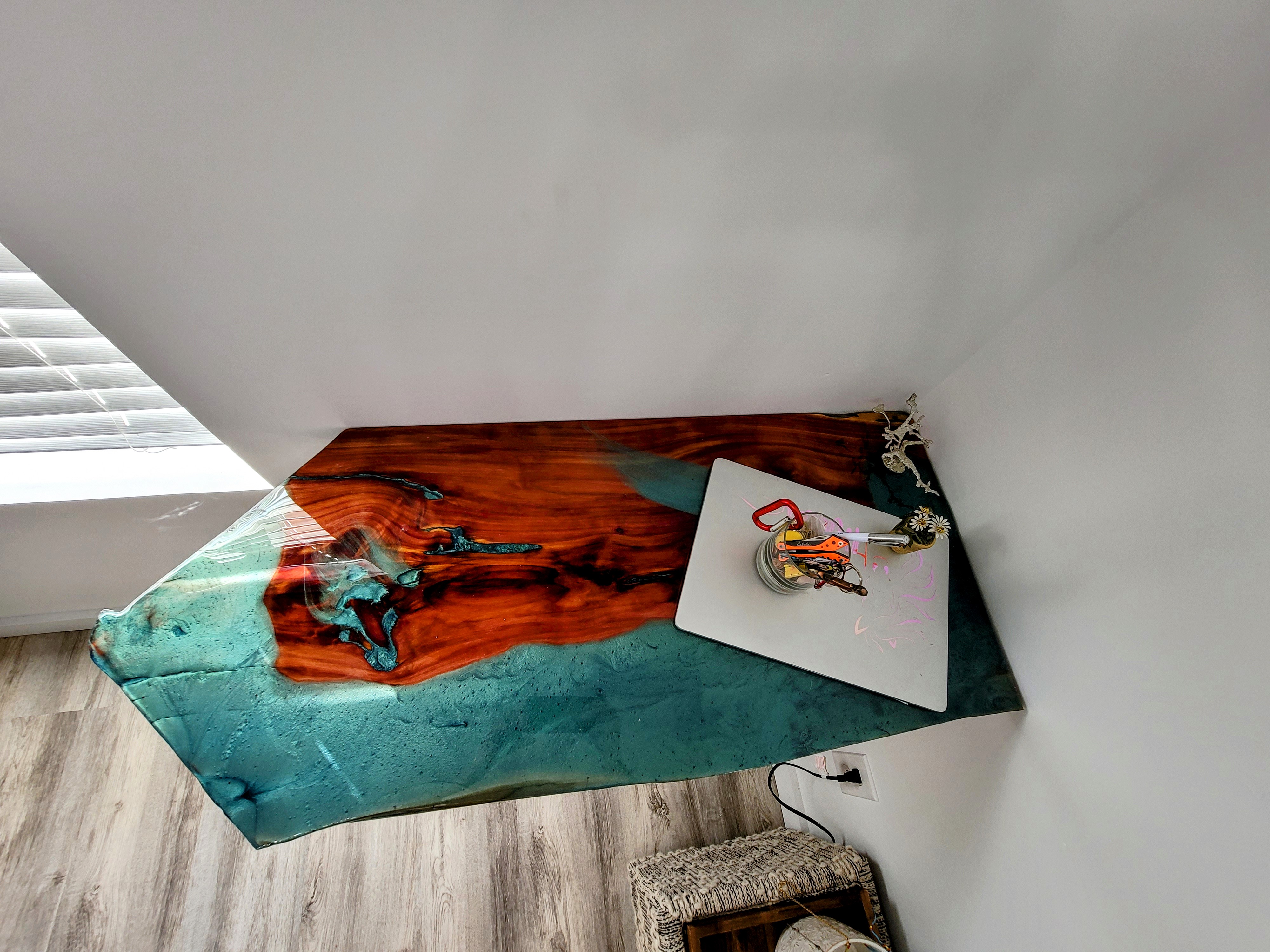 Top-down look at the cedar slab desk and rich turquoise resin detail.